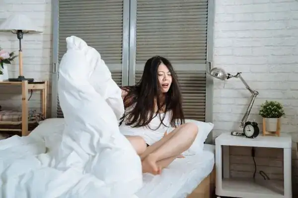 Image of woman getting up because of nighttime leaks Exeter